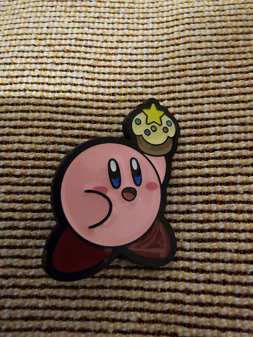 Enamel Pin featuring the Character Kirby Holding a Small, Star-topped Dessert